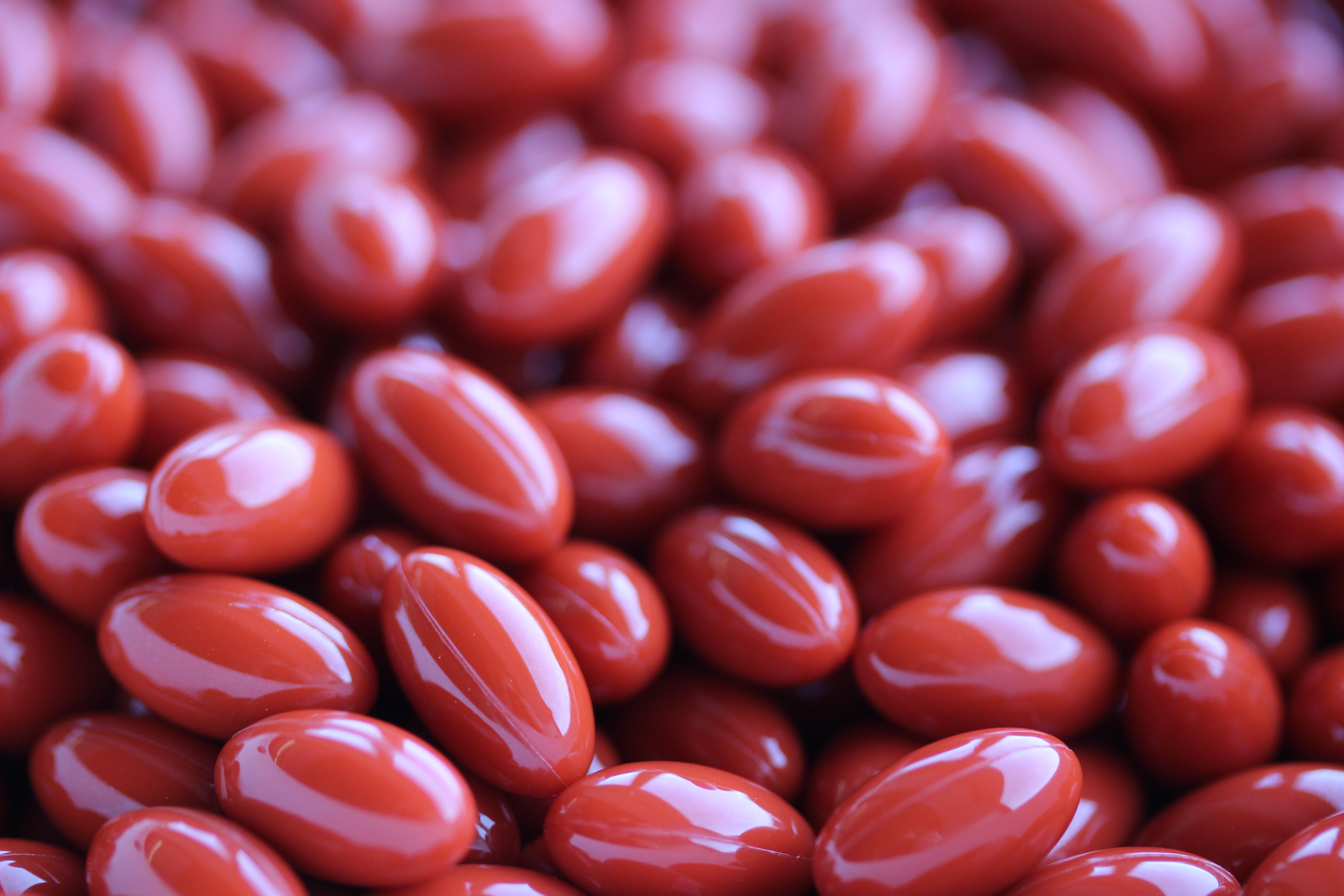 large quantities of red colored softgels 